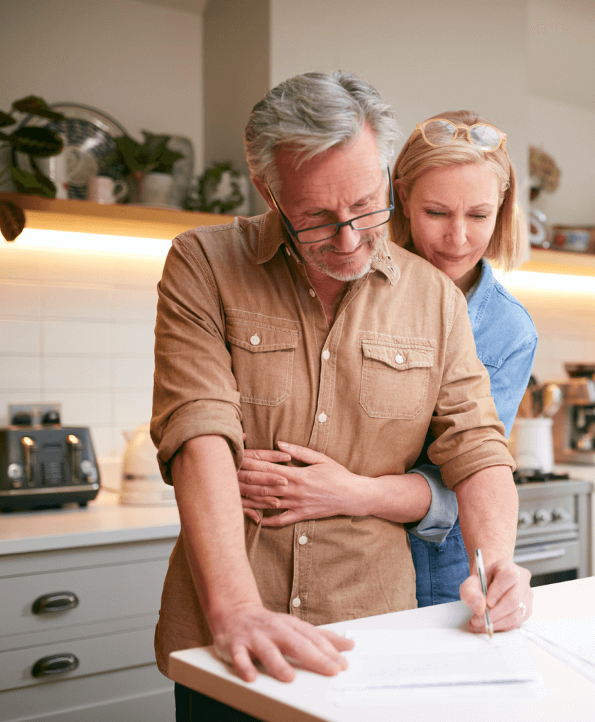 Older couple signing life insurance contract