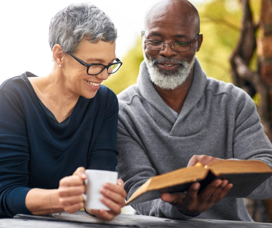 older couple with glasses reading book