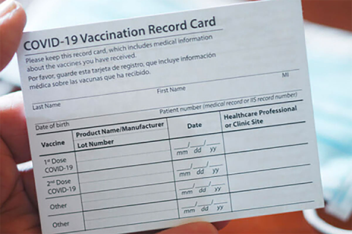 Person Holding Covid-19 Vaccine Card