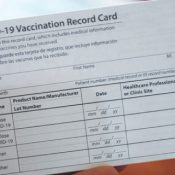 Person Holding Covid-19 Vaccine Card