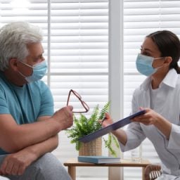 Medical Professional Explaining Information to Older Man