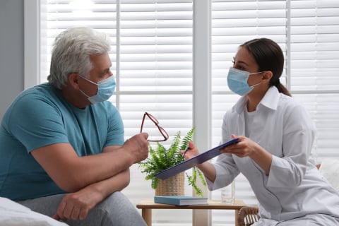 Medical Professional Explaining Information to Older Man