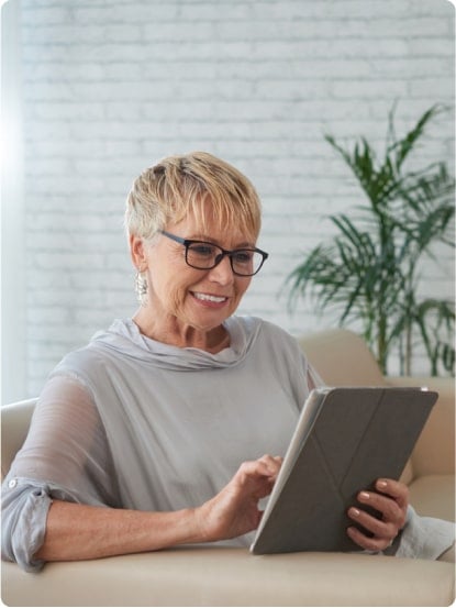 older woman reading tablet