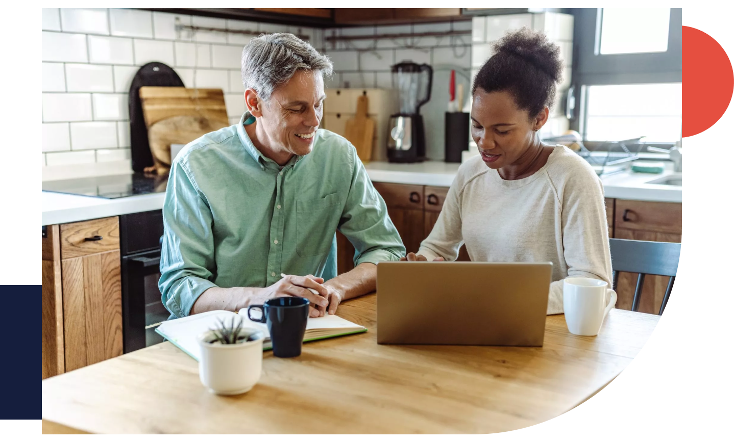 Multi-racial mature couple discussing investments and finance at home