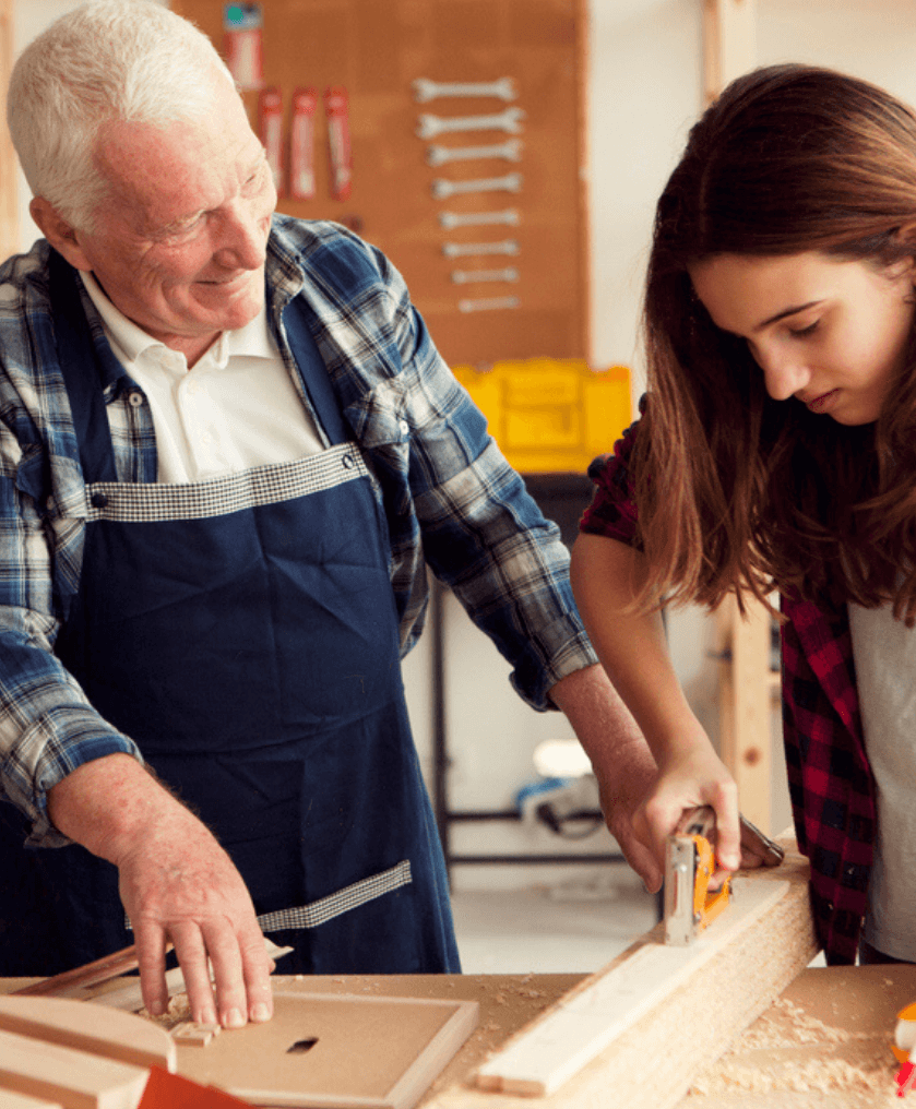 Senior teaching word working to a teenage girl