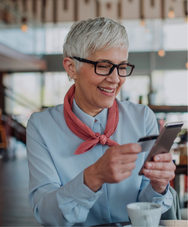 Woman using smartphone and credit card