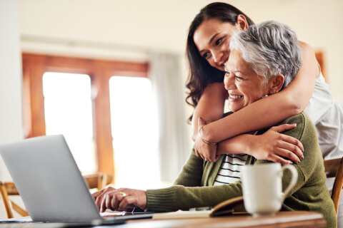 Senior happy using laptop