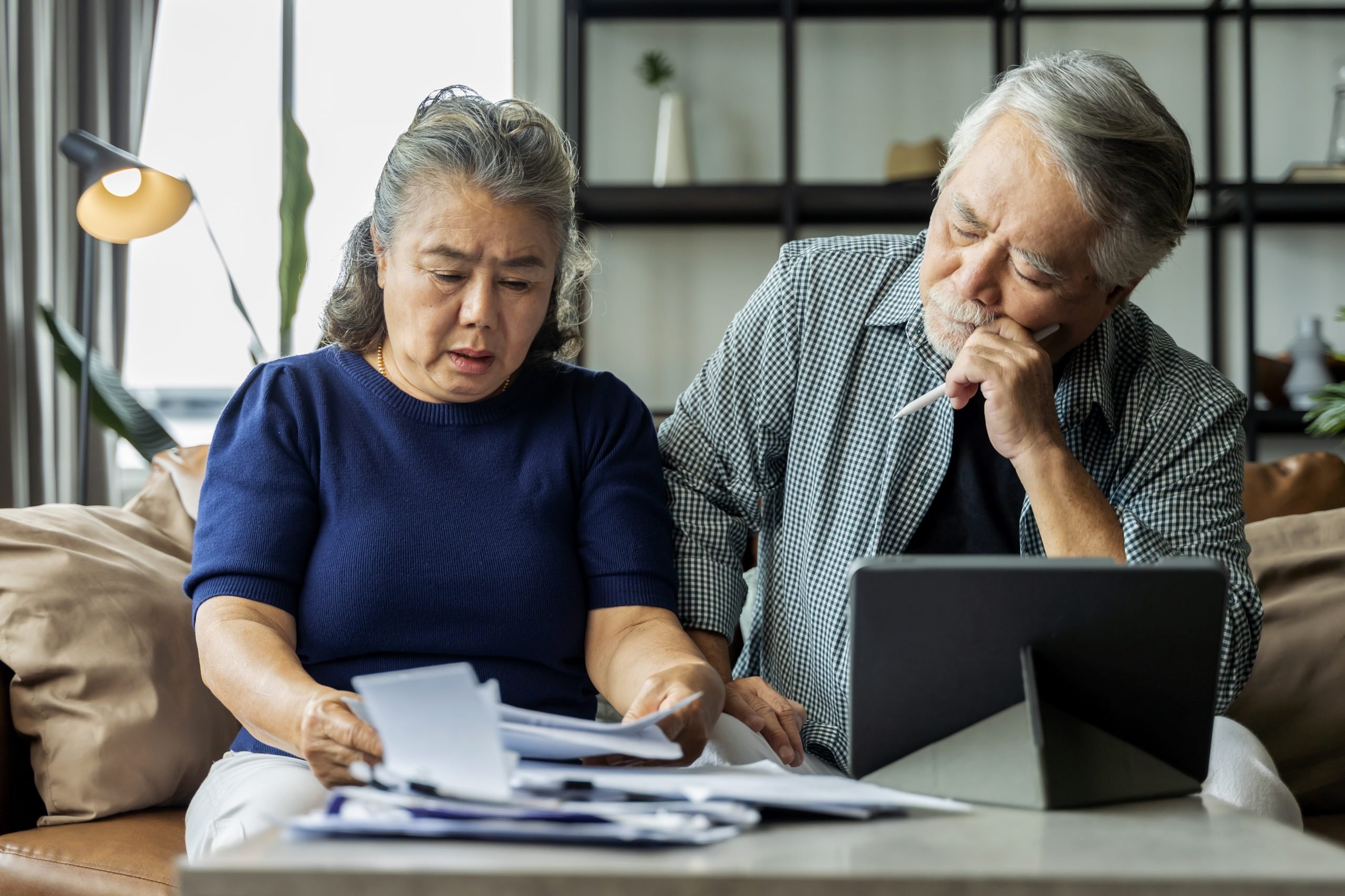 Senior couple reviewing paperwork together