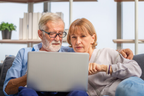 Seniors looking at laptop