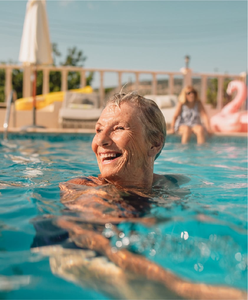 Smiling senior woman in pool, summer