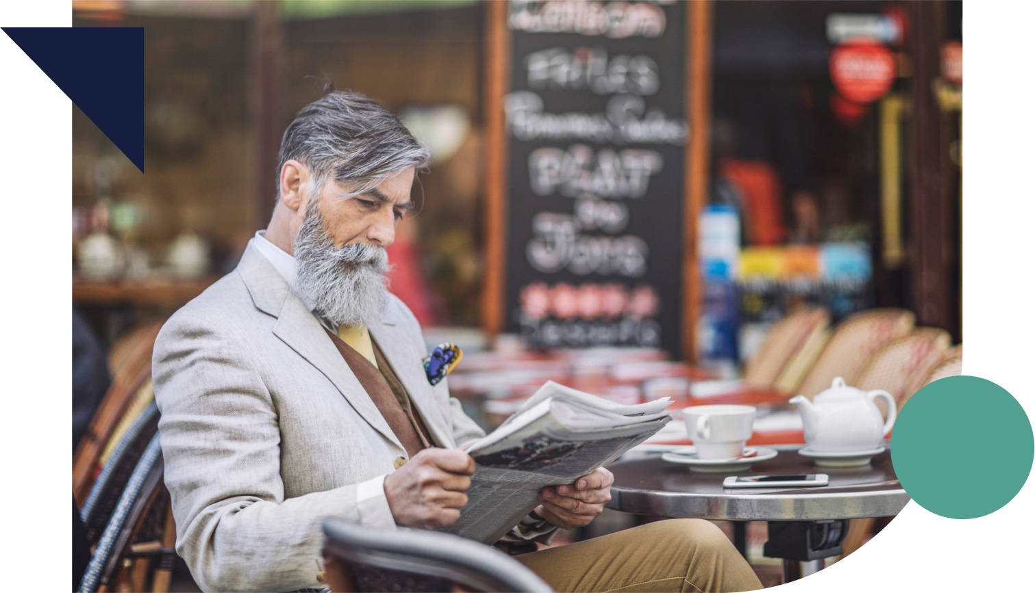 Well-dressed senior reading a newspaper at a cafe