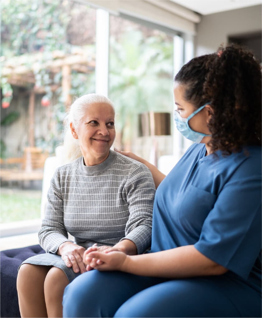 Elderly woman chatting with caretaker