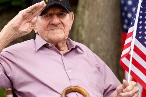 Veteran sitting with flag