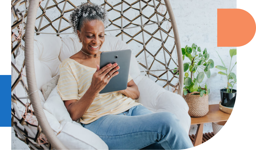 Woman using ipad while sitting in chair